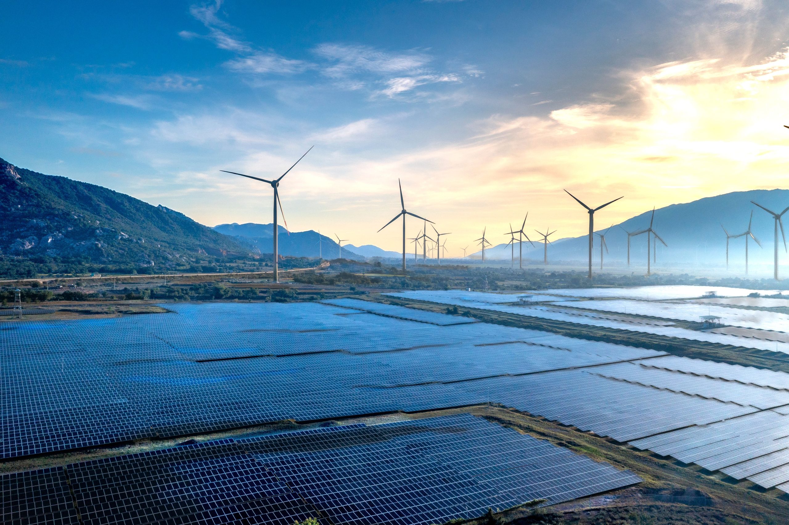 Wind turbines and a solar field across an energy landscape
